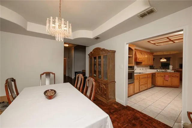 a kitchen with stainless steel appliances a table and chandelier
