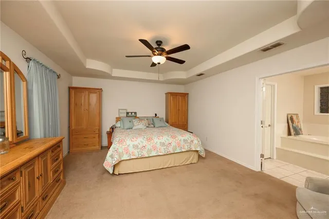 a spacious bedroom with a bed and window