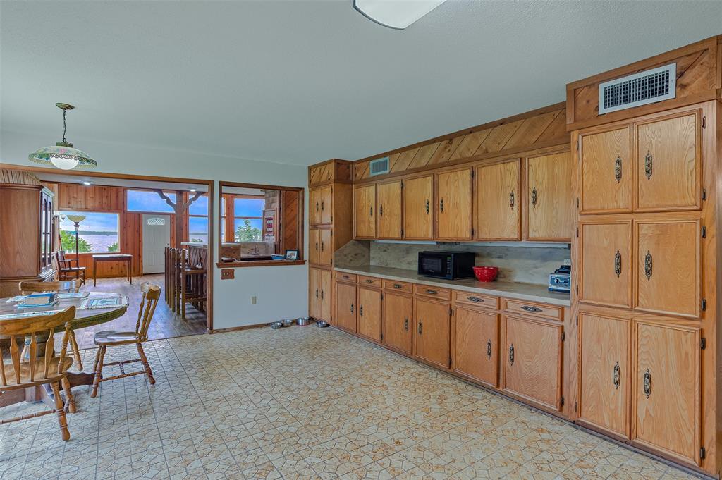 10307 Pirogue Road Oil City, LA 71061 - Photo 9 of 36 a kitchen with cabinets a sink and appliances