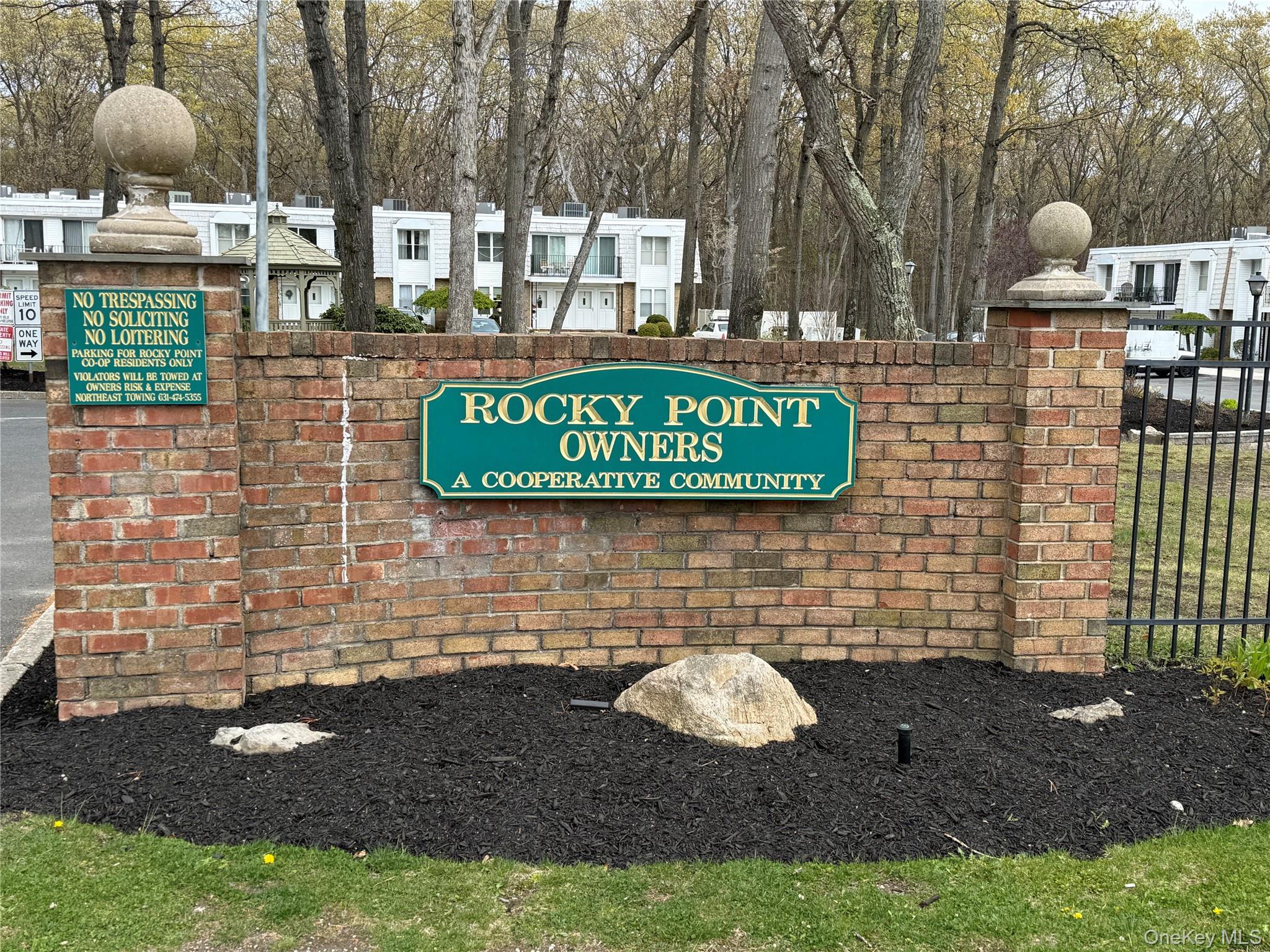 a sign that is sitting on a brick wall