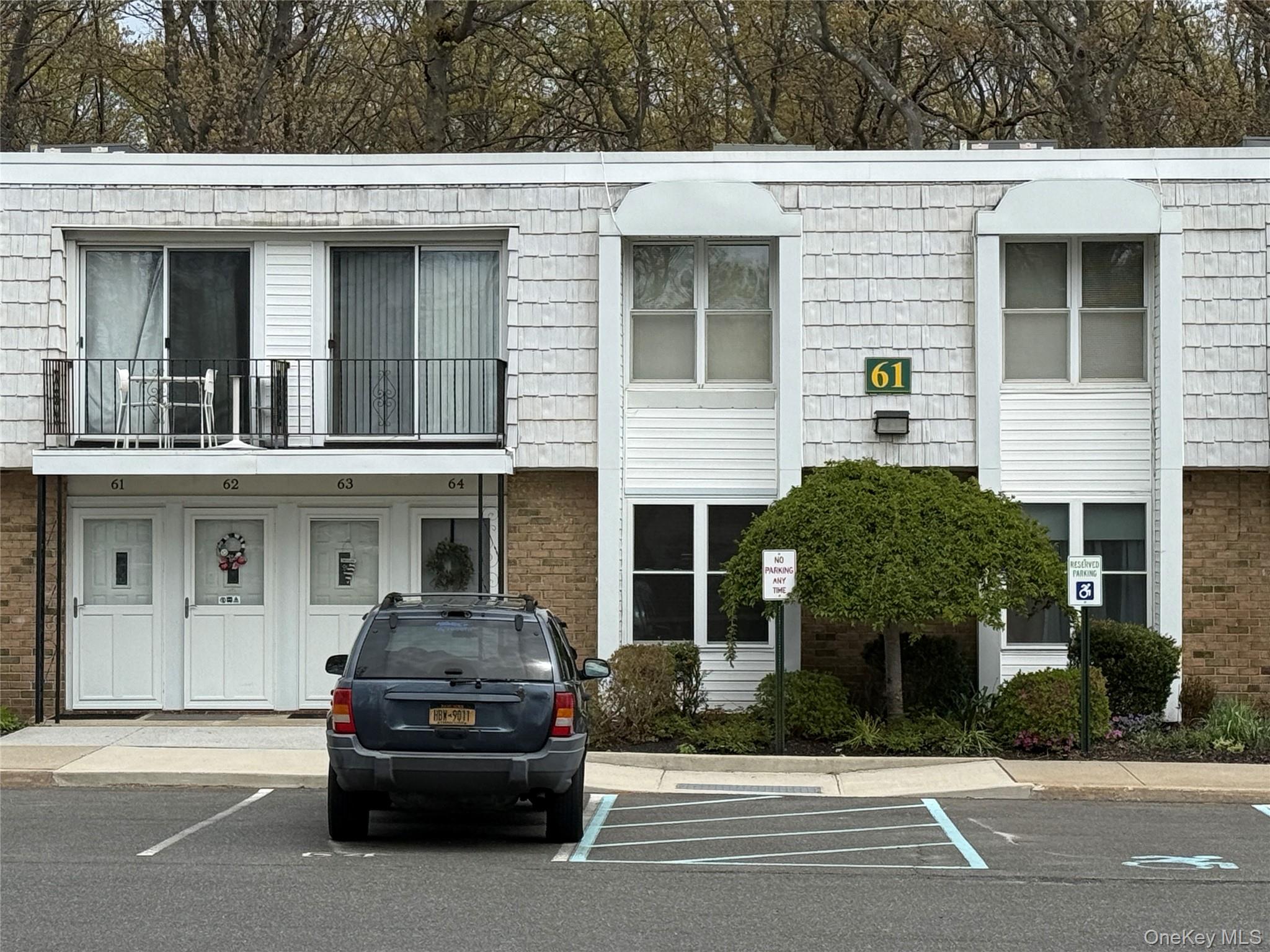 61 Rocky Point Yaphank Road, Unit 61 Rocky Point, NY 11778 - Photo 11 of 12 a car parked in front of a white building