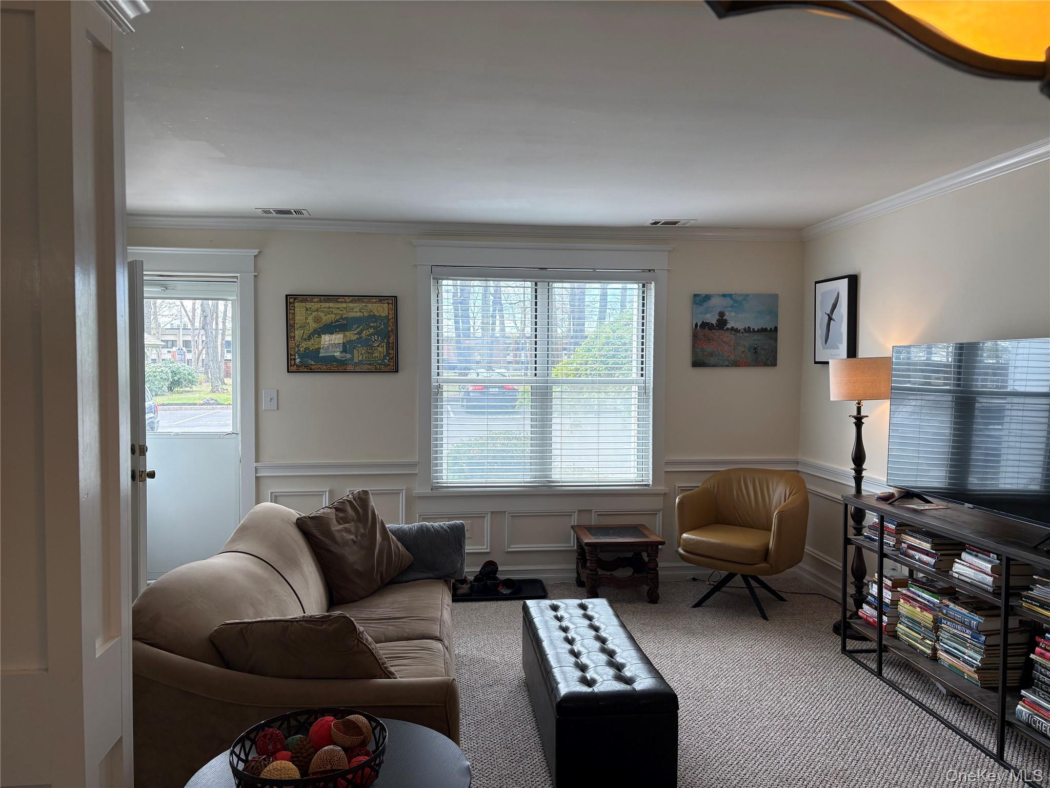 61 Rocky Point Yaphank Road, Unit 61 Rocky Point, NY 11778 - Photo 3 of 12 a living room with furniture a rug and a window