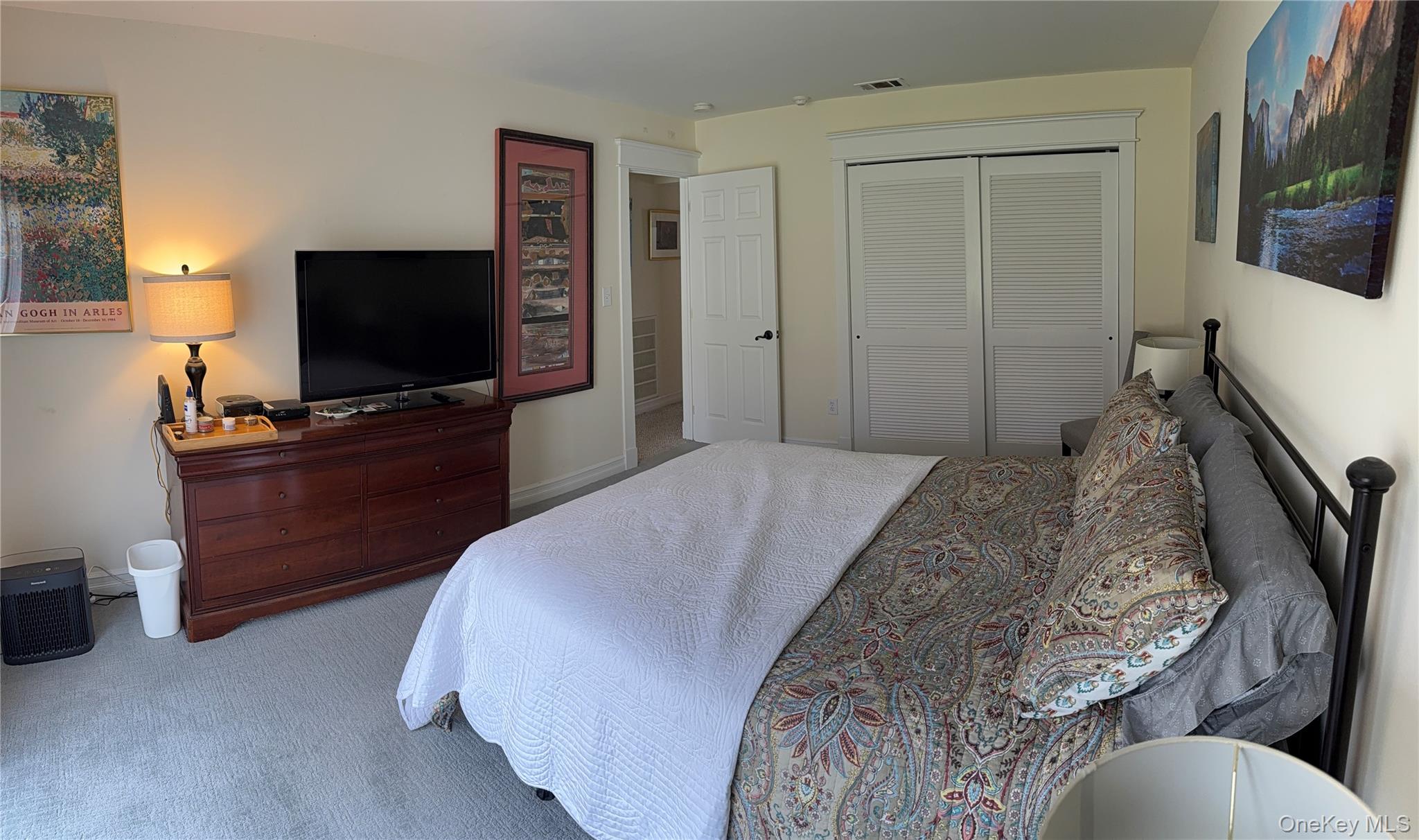 61 Rocky Point Yaphank Road, Unit 61 Rocky Point, NY 11778 - Photo 6 of 12 a bedroom with a bed and flat screen tv