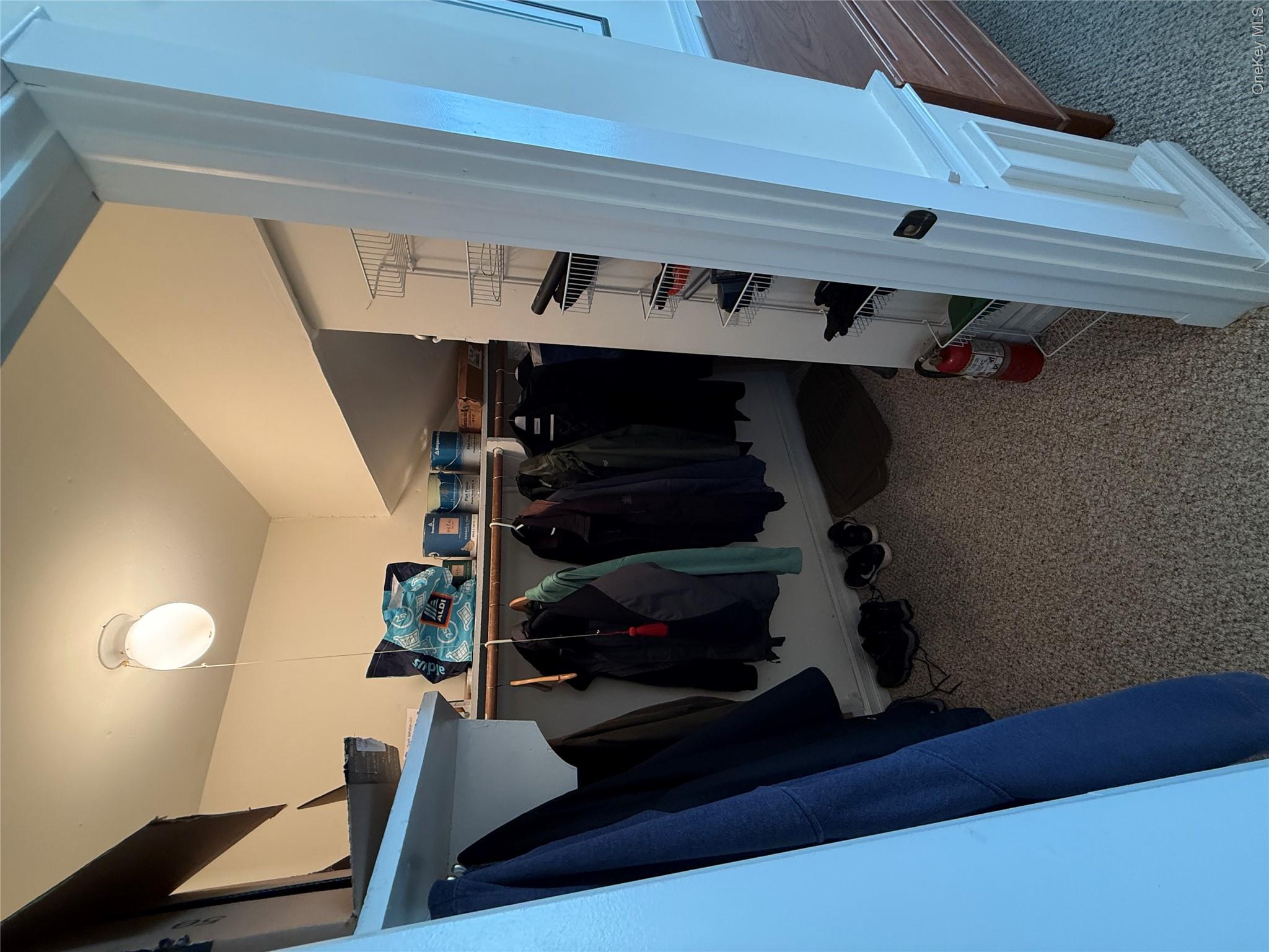 61 Rocky Point Yaphank Road, Unit 61 Rocky Point, NY 11778 - Photo 10 of 12 a view of walk in closet with clothes and shoes