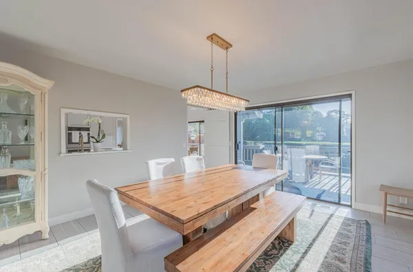 a large kitchen with a table and chairs