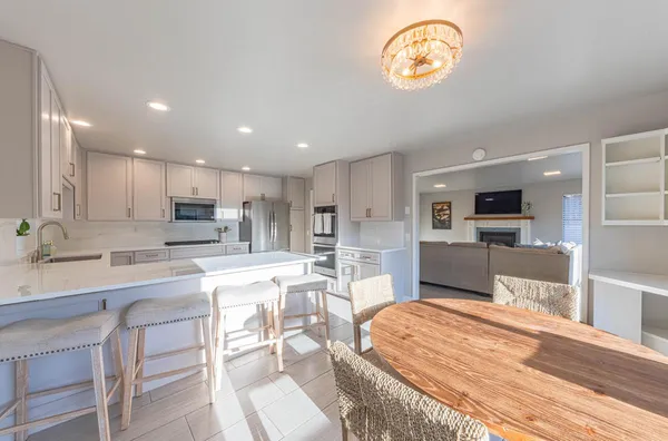a kitchen with stainless steel appliances kitchen island granite countertop a sink and cabinets
