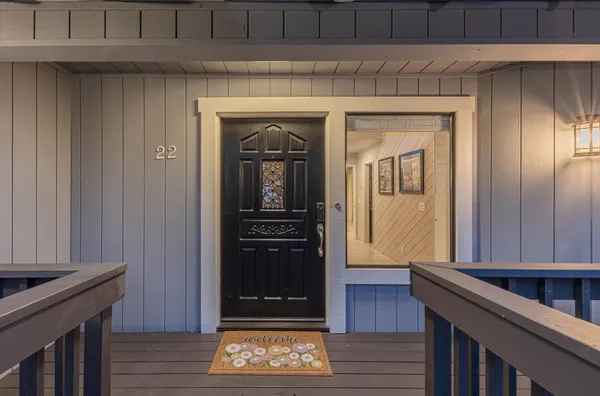 a view of a house with large windows and deck