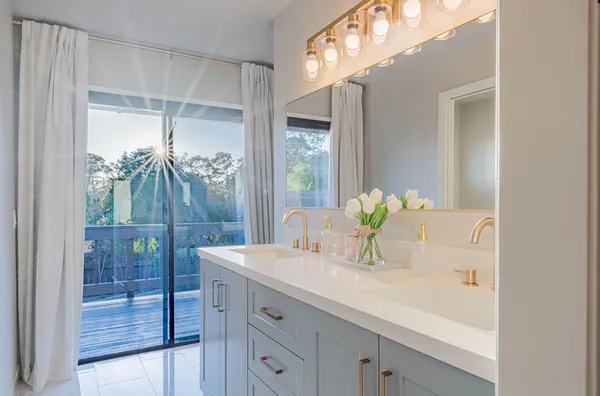 a spacious bedroom with a bed and a large mirror