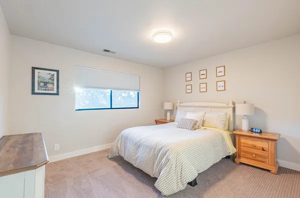 a view of a patio with table and chairs with plants and wooden fence