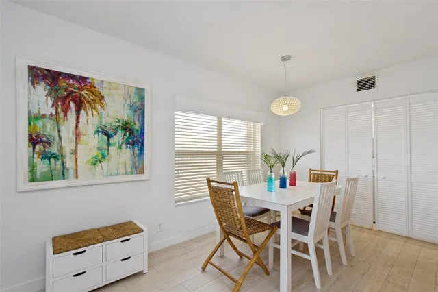 a view of a dining room with furniture and a chandelier