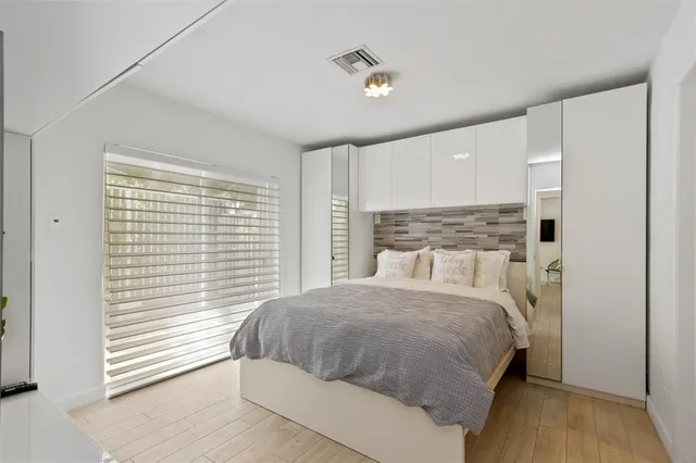 a bedroom with a large bed and a large window