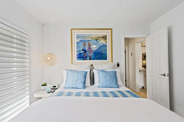 a bedroom with two beds and a chair