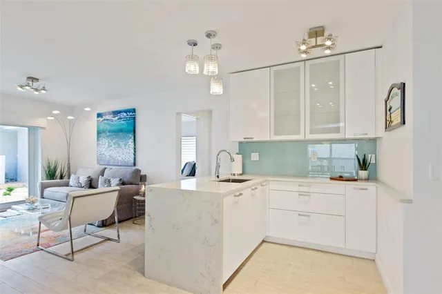 a kitchen with a sink cabinets and chandelier