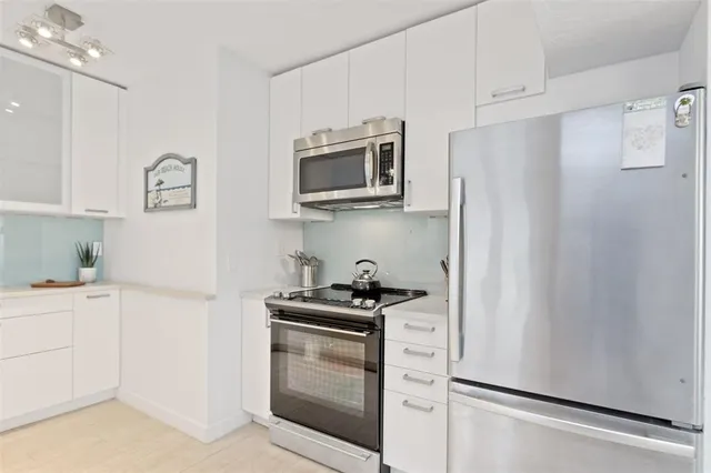 a kitchen with stainless steel appliances a refrigerator stove and microwave