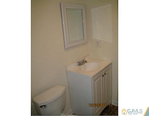 24 Hill Road Edison, NJ 08817 - Photo 13 of 16 a bathroom with a sink toilet and mirror