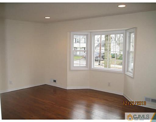 24 Hill Road Edison, NJ 08817 - Photo 3 of 16 an empty room with wooden floor and windows