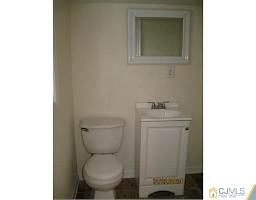 24 Hill Road Edison, NJ 08817 - Photo 8 of 16 a bathroom with a toilet a sink and mirror