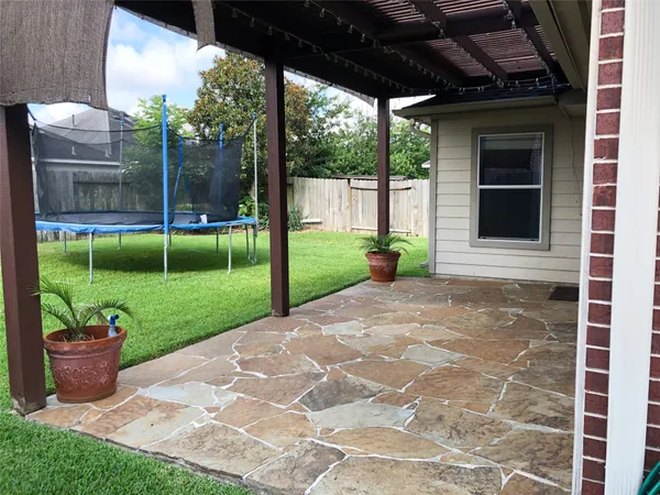 a view of a house with backyard and porch