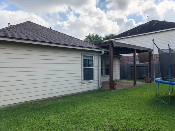 a backyard of a house with table and chairs