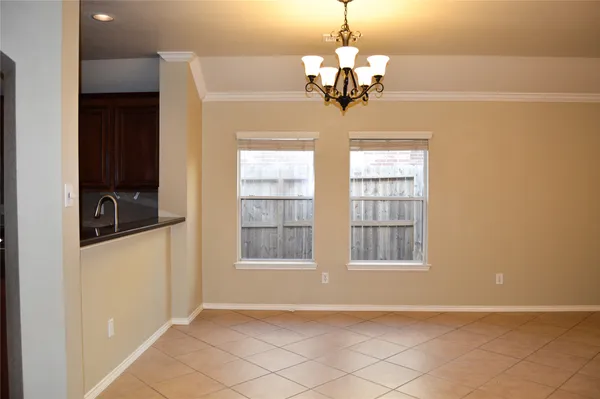 a view of a livingroom with a chandelier furniture and windows