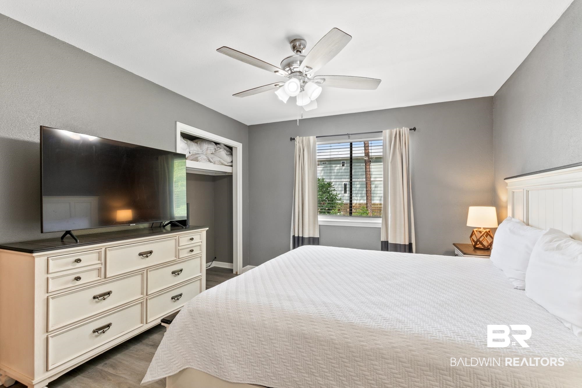 25925 -C Canal Road, Unit 203 Orange Beach, AL 36561 - Photo 21 of 57 Bedroom with dark hardwood / wood-style flooring and ceiling fan