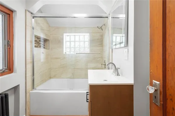 a bathroom with a sink a mirror and a bathtub