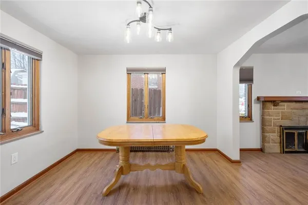 a view of a room with wooden floor and fireplace
