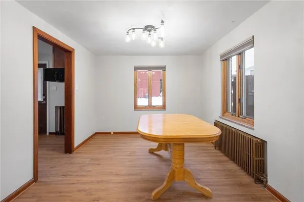 wooden floor with chandelier fan and windows