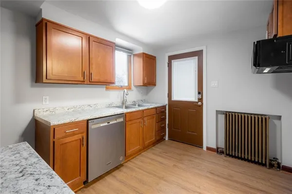 a kitchen with stainless steel appliances granite countertop a sink stove and cabinets