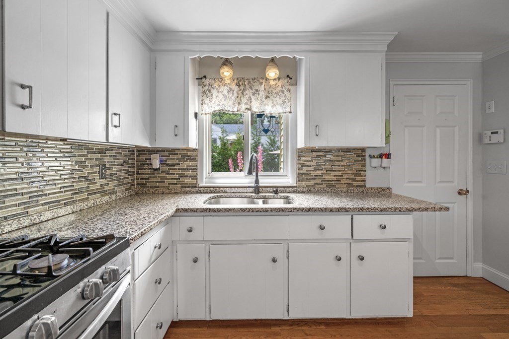 6 Ames Road Marblehead, MA 01945 - Photo 11 of 32 a kitchen with granite countertop white cabinets and a stove