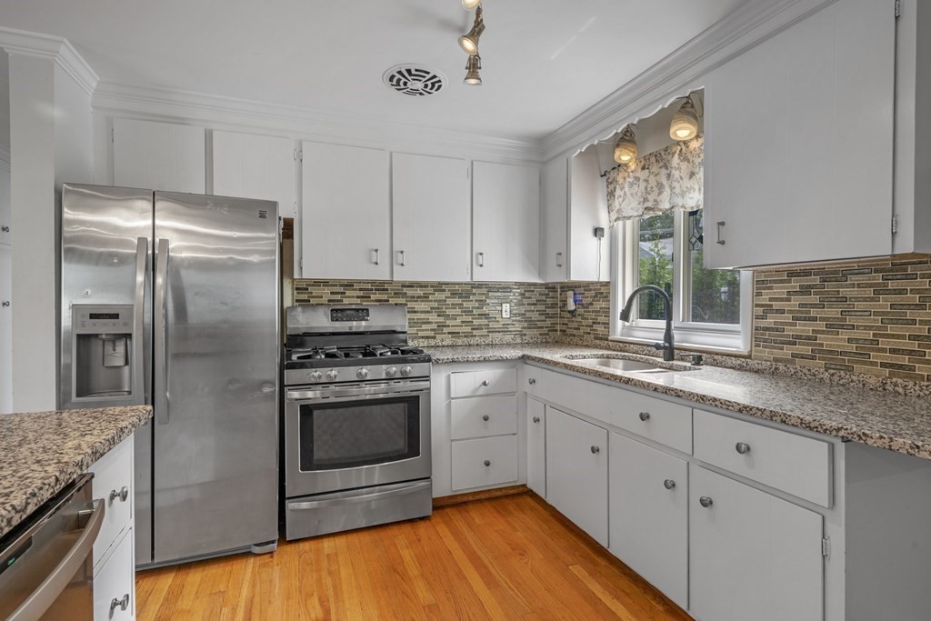 6 Ames Road Marblehead, MA 01945 - Photo 12 of 32 a kitchen with granite countertop stainless steel appliances a sink cabinets and a window