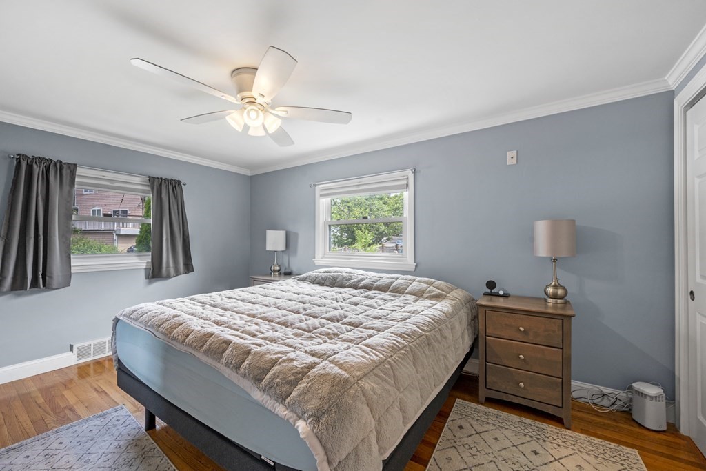 6 Ames Road Marblehead, MA 01945 - Photo 17 of 32 a bedroom with a bed and a chandelier