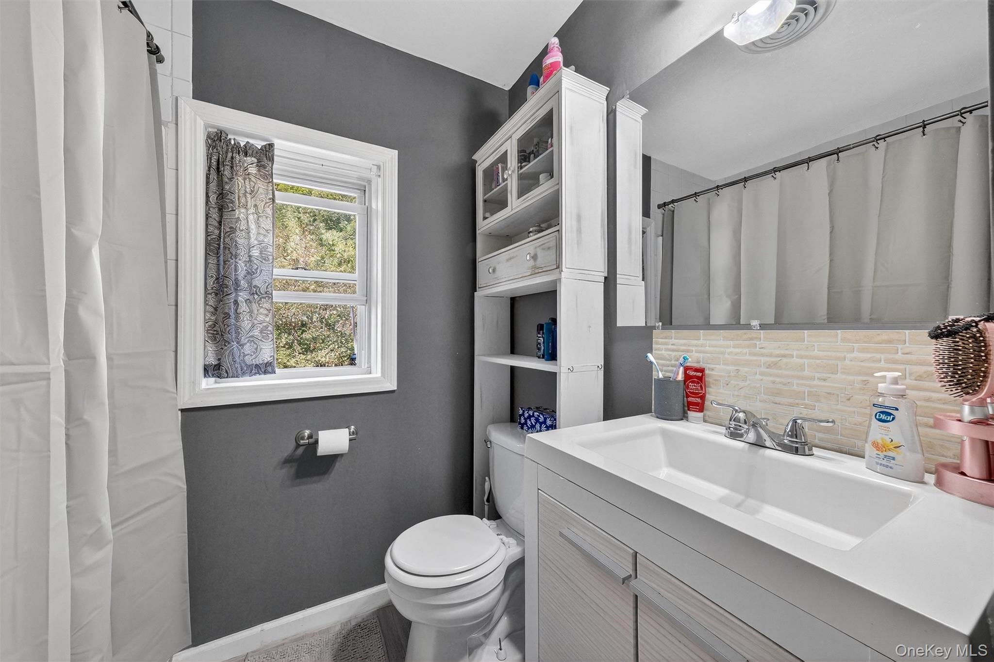 27 Peckham Road Poughkeepsie, NY 12603 - Photo 16 of 27 a bathroom with a sink toilet and a mirror