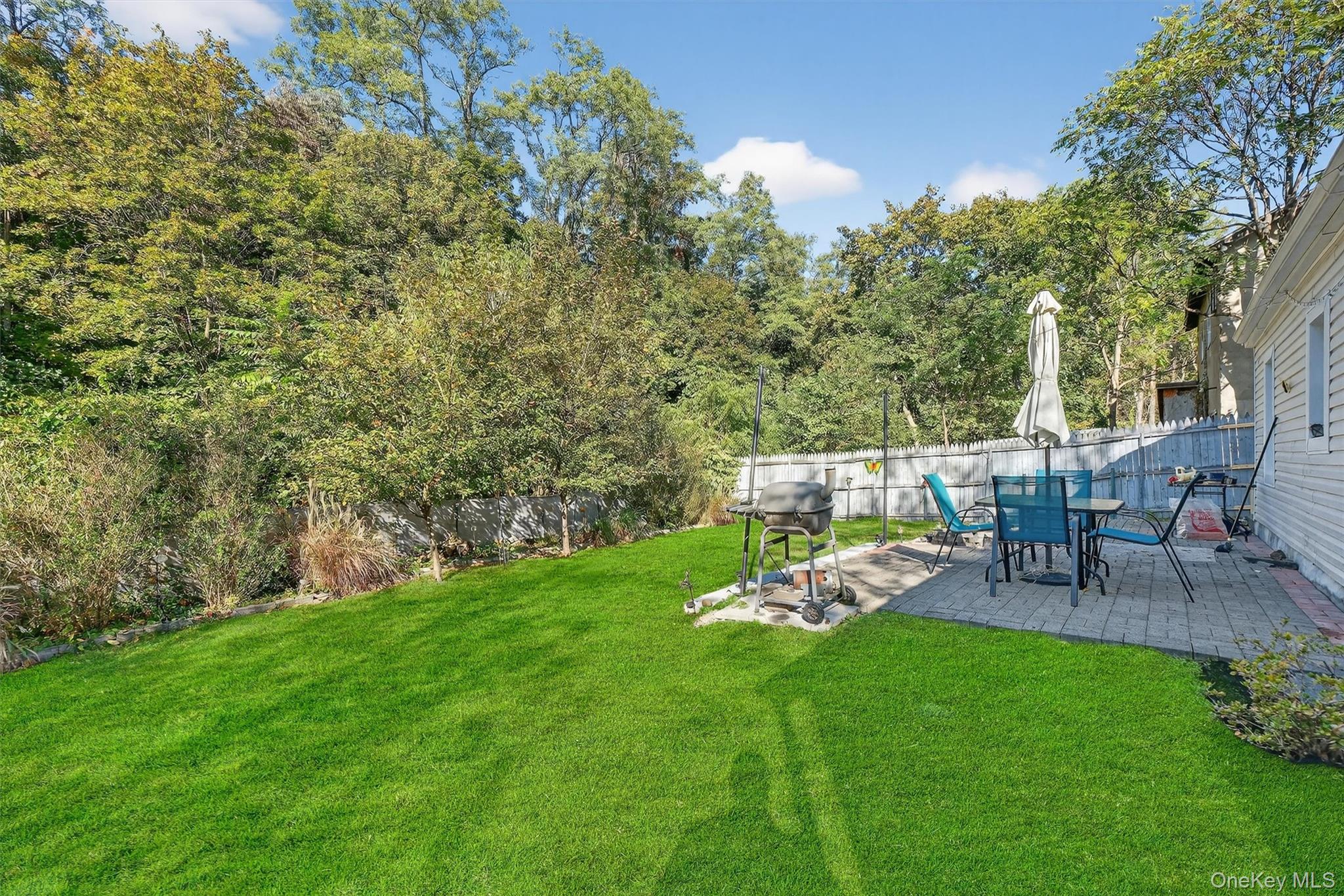 27 Peckham Road Poughkeepsie, NY 12603 - Photo 22 of 27 a view of a chair and table on the green field