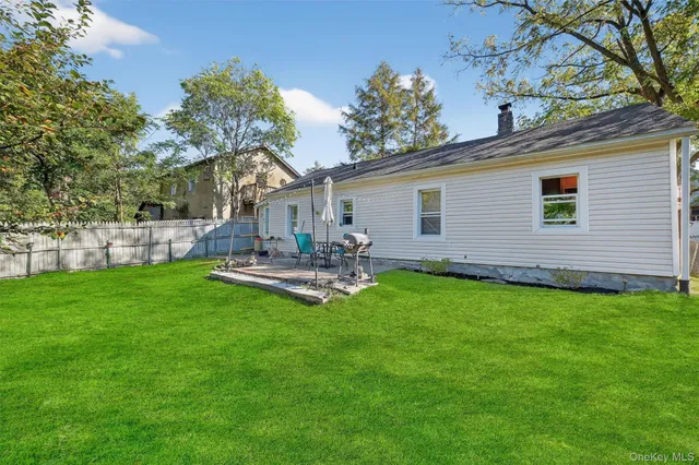 a front view of a house with patio and garden