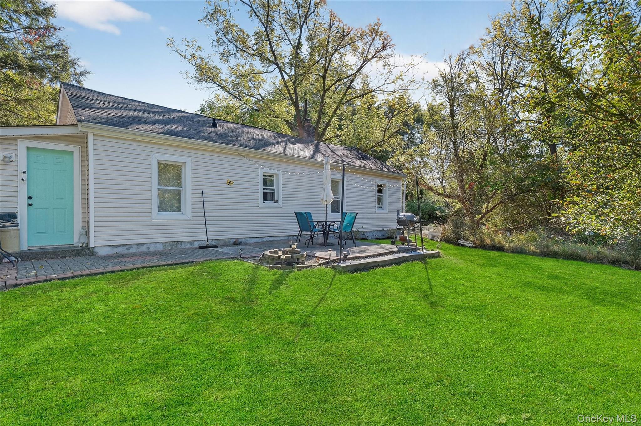 27 Peckham Road Poughkeepsie, NY 12603 - Photo 26 of 27 a view of a backyard with table and chairs and large tree