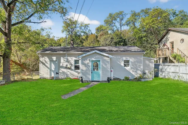 a front view of a house with a garden