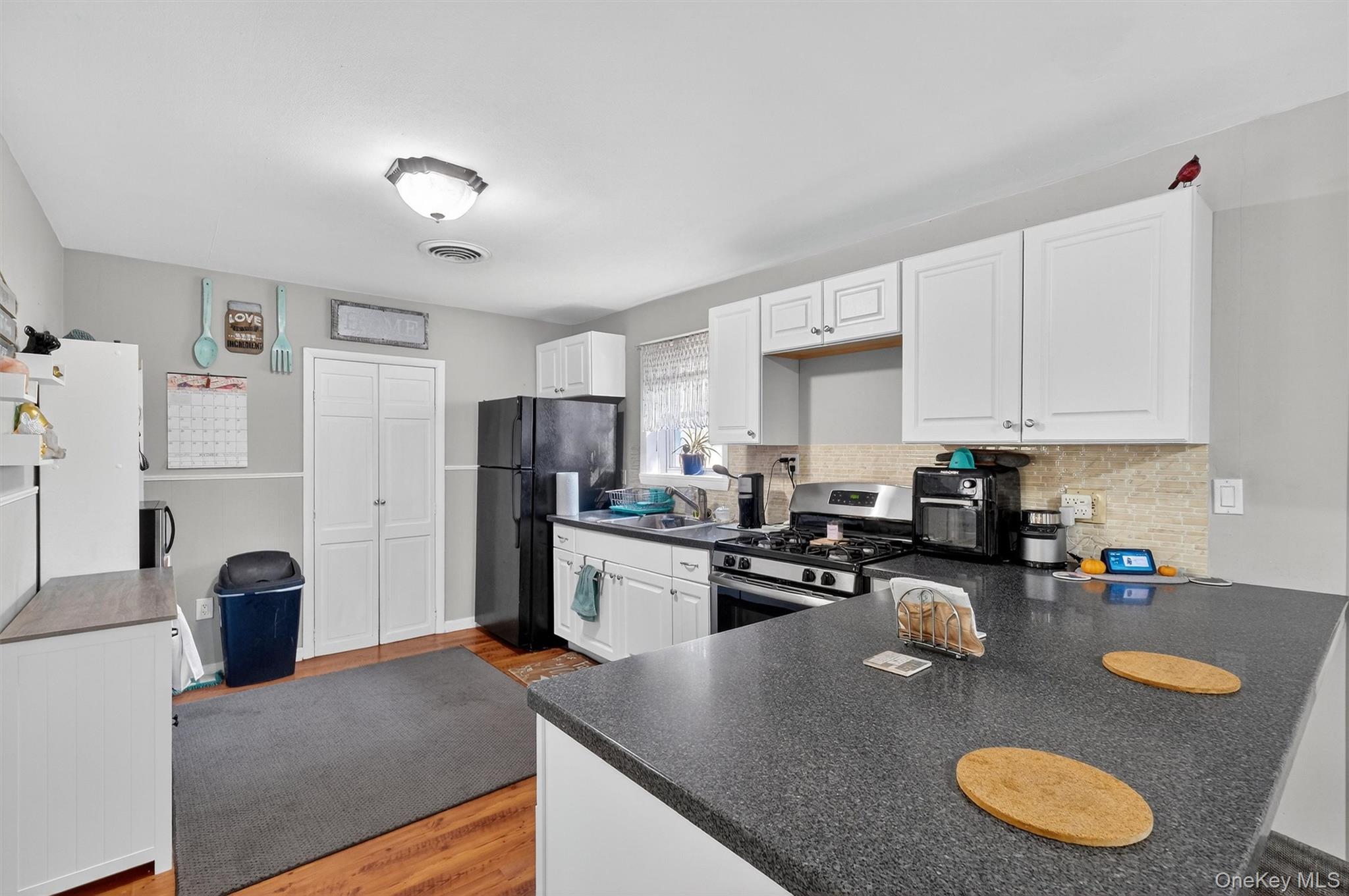 27 Peckham Road Poughkeepsie, NY 12603 - Photo 9 of 27 a kitchen with stainless steel appliances granite countertop a sink dishwasher stove top oven and refrigerator