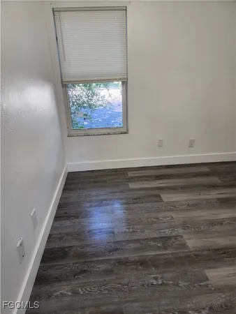 a view of a hallway with wooden floor and a fireplace