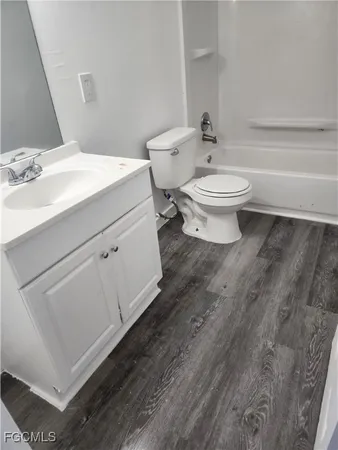 a bathroom with a toilet a sink and bathtub