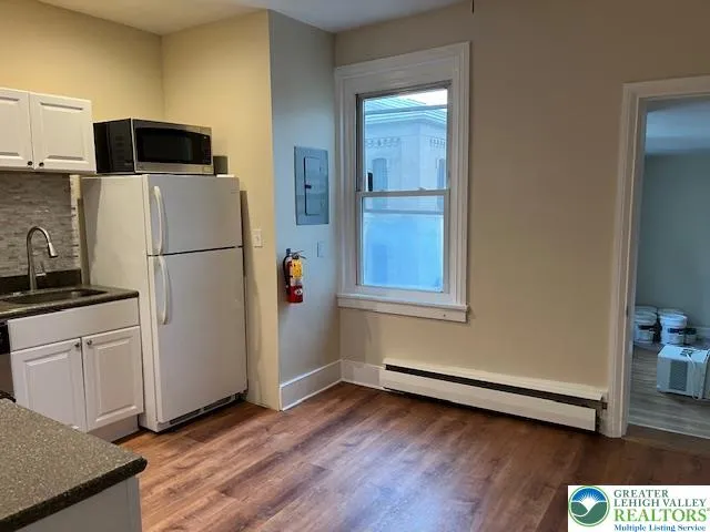 a kitchen with granite countertop a sink and a stove top oven