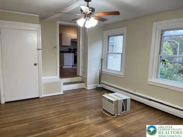 a room with hard wood floors and a window