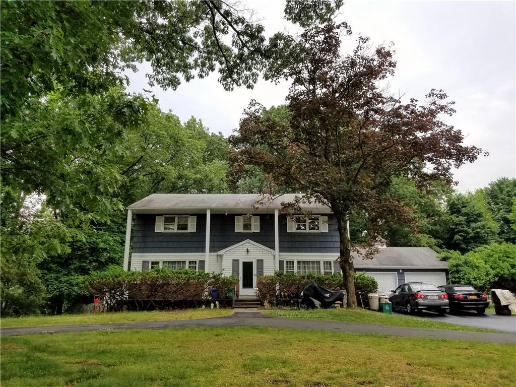 2 Rockingham Road Spring Valley, NY 10977 - Photo 1 of 1 a front view of a house with a garden and trees