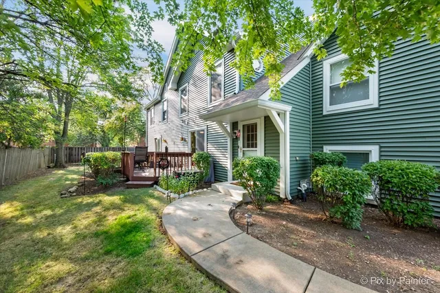 a view of a house with backyard sitting area and garden