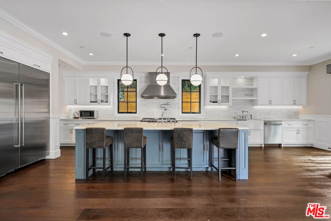 9348 Cresta Drive Los Angeles, CA 90035 - Photo 21 of 44 a open kitchen with stainless steel appliances granite countertop a stove and kitchen island