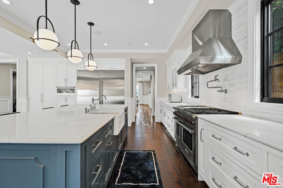 9348 Cresta Drive Los Angeles, CA 90035 - Photo 23 of 44 a kitchen with stainless steel appliances a stove sink and cabinets