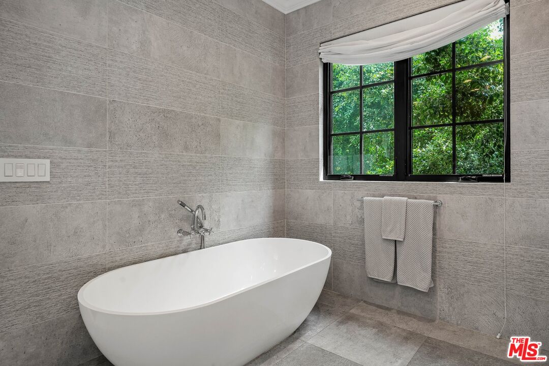 9348 Cresta Drive Los Angeles, CA 90035 - Photo 32 of 44 a white bath tub sitting in a bathroom next to a window