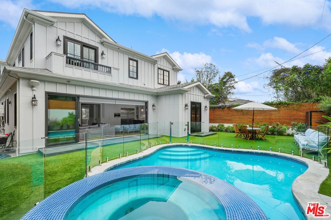 9348 Cresta Drive Los Angeles, CA 90035 - Photo 44 of 44 a view of a house with a swimming pool and a yard