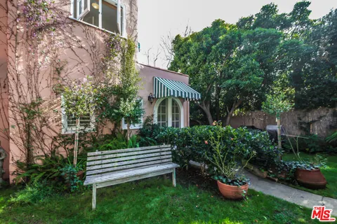 a view of a house with backyard and sitting area