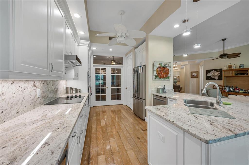 a large kitchen with stainless steel appliances kitchen island granite countertop a large counter top and wooden cabinets